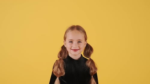 Little Blonde Girl in Witch Costume on Halloween at Orange Studio Background