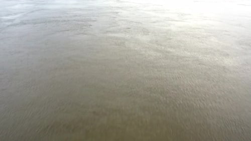 Pont de Pierre bridge in Bordeaux France with Garonne river on overcast day, Aerial tilt up approach
