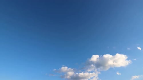 Clouds Moving Slowly Across a Blue Sky