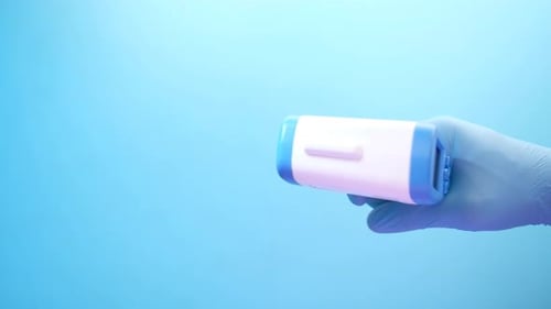 Hand Holding Infrared Thermometer To Measuring Temperature