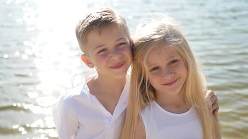 On a Sunny spring day, children play with colorful paper boats in the river.
