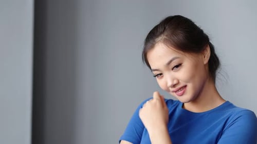 Smiling Young Adult Woman Posing Indoors
