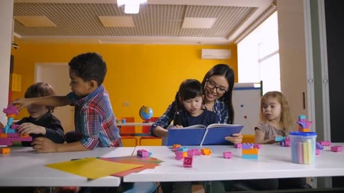 Children Building and Learning with Teacher in Classroom