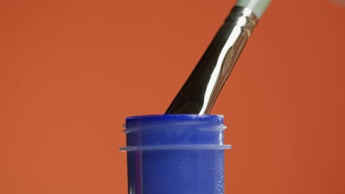 Blue Paint Isolated on Orange Background