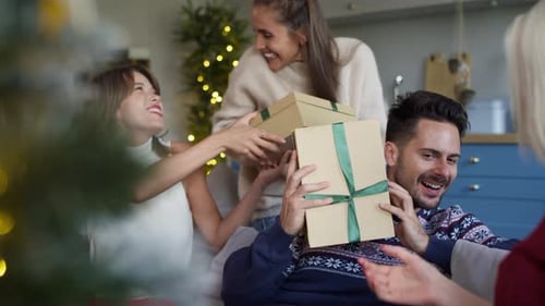Friends Giving Gifts at Christmas Gathering