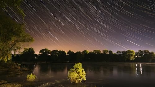 Star Trails Time-Lapse Over Still Lake at Night