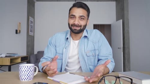 Young Happy Indian Business Man Having Video Call at Home Office Using Pc