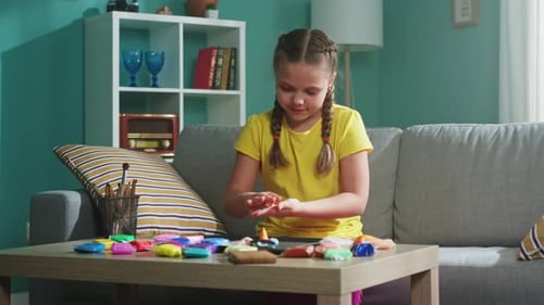 Niña pequeña está esculpiendo helado con plastilina