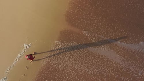 Walking on Beach with Waves from Aerial View