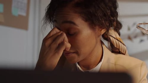 Tired Afro-American Businesswoman Working Late in Office