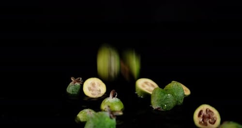 The Feijoa Slices Fall on the Water with Splashes.