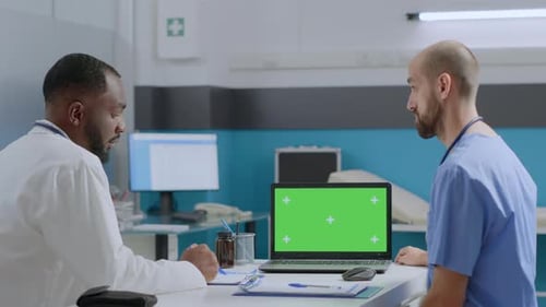 Doctors Discussing Medical Data with Chroma Key Laptop
