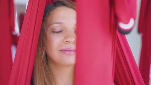 Woman Meditating in Aerial Yoga Red Hammock