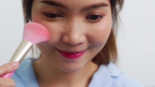 Happy female using beauty cosmetics to improve herself ready to working at home