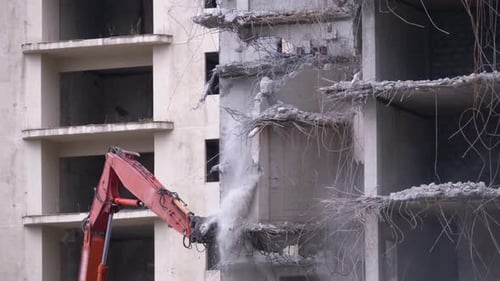 Excavator Arm Demolishes Abandoned Concrete Building