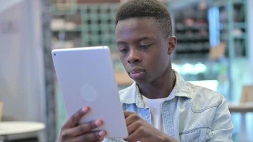 Young Man Using Tablet in Urban Setting