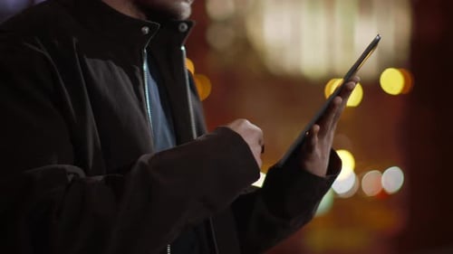 Guy Hands Surfing Internet on Tablet Outdoors. Man Hands Using Tablet on Street.