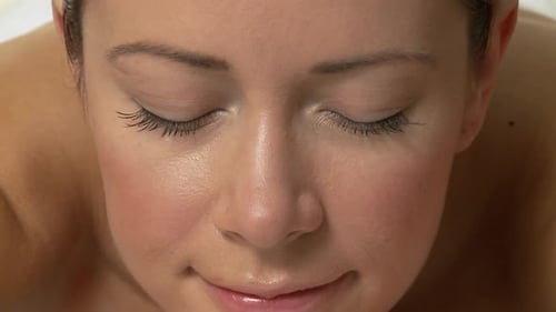 Woman Relaxing on Massage Table at Day Spa