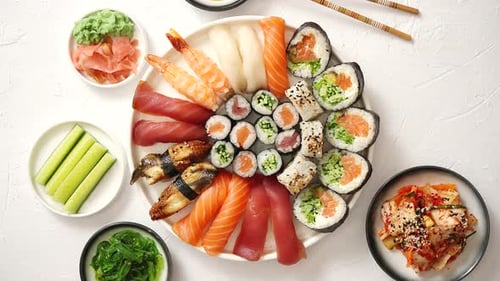 Various Sushi Rolls Placed on Round Ceramic Plate