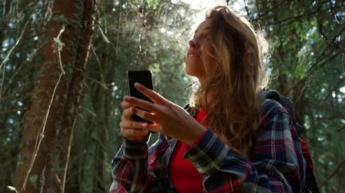 Girl Using Smartphone in Forest