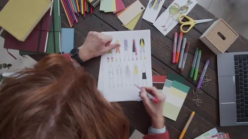 Timelapse of Male Designer Coloring Fashion Sketches with Pencils