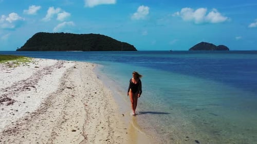 Sexy beauty models travelling spending quality time at the beach on clean white sand and blue backgr