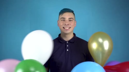 Man Smiling with Colorful Birthday Party Balloons