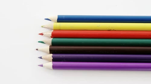 Close-up of colored pencils arranged in a row