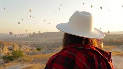 Woman Enjoys Hot Air Balloons in Cappadocia at Sunrise