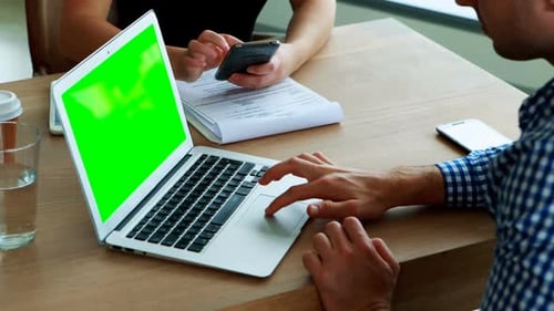 People Working with Laptop and Smartphone in Office