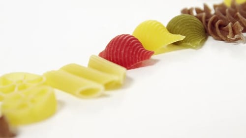 Variety of Colorful Uncooked Pasta Shapes Close Up