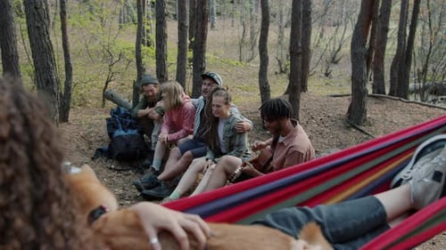 Friends Relaxing Together in Forest Camping Scene