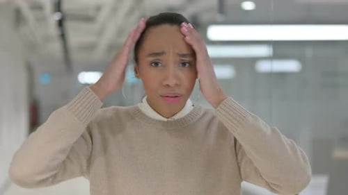 Young Woman Looking Stressed with Hands on Head