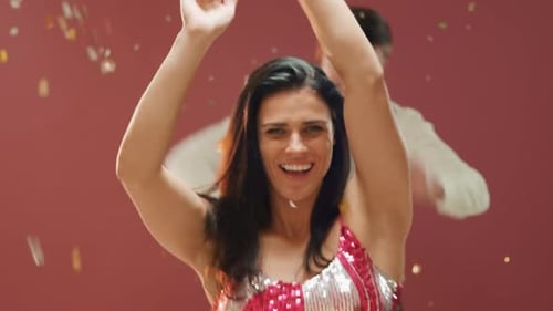 Woman Blows Confetti While Man Dances