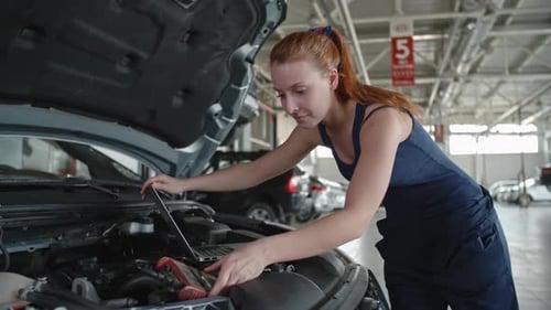 Female Mechanic Enjoying her Job