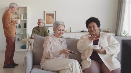 Senior Women Relaxing Indoors, Watching Television