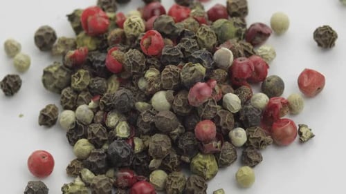 Colorful Mixed Peppercorns Rotating on White Surface