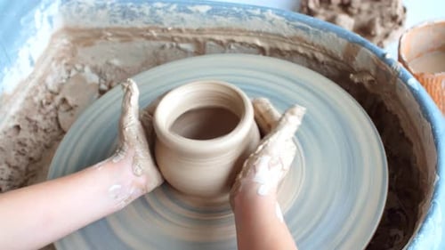 Hands Shaping Clay on Pottery Wheel