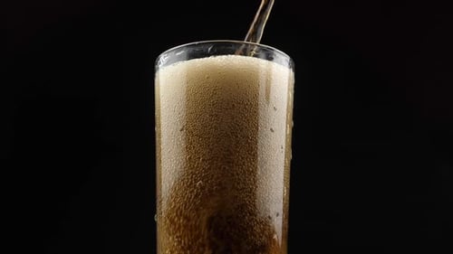 Pouring a Refreshing, Fizzy Drink into a Glass
