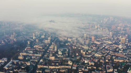 Aerial View Above To Very Dense Morning Fog Over City. Smog or Fog in the City. Problem of Pollution