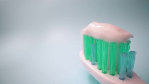 Extreme Macro Video Filming Toothbrush on a Blue Background in Motion Toothpaste on the Brush