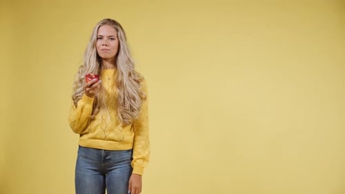 Woman Enjoying a Fresh Red Apple