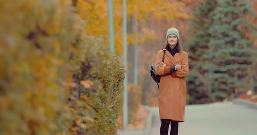 Young Girl Walking in Autumn Park