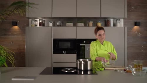 Woman Chef Cooking Pasta in Modern Kitchen