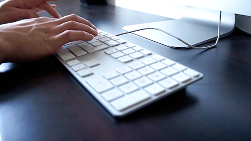 Hands Typing on Modern Computer Keyboard