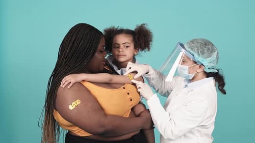 Child Getting Bandage After Vaccination at Doctor Office