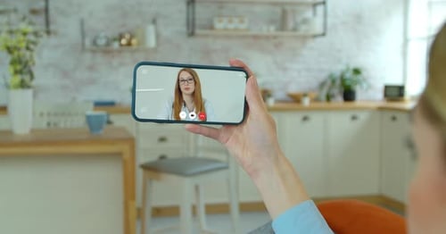 Woman Using Telehealth App on Phone with Doctor