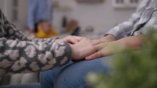 Close-up: Holding Hands in Loving Family Moment