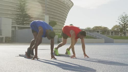 Two athletes preparing for race in stadium
