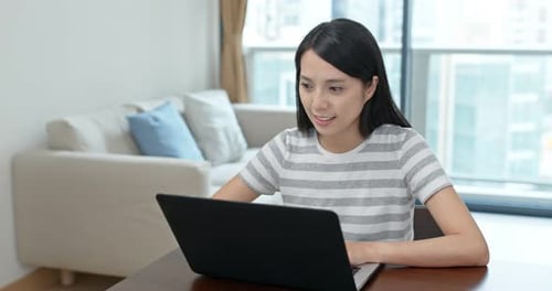 Woman Works on Laptop at Home